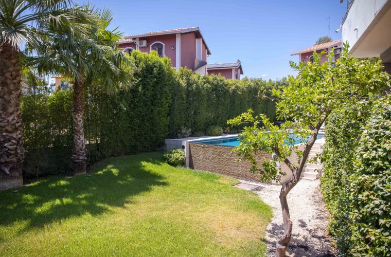 Children will love playing on the lawn right next to the pool.